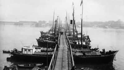 Small boats create a pontoon bridge over the Scheldt River in Antwerp, Belgium, for residents and troops escaping the German Army.