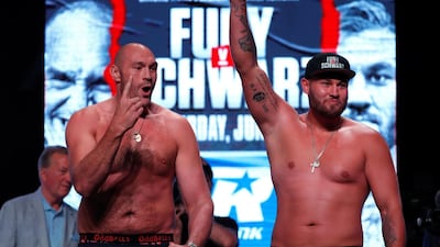 Tyson Fury and Tom Schwarz during the weigh in. REUTERS