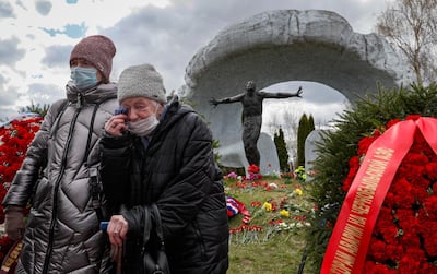 Women mourn near a tomb of a victim of the Chernobyl nuclear power plant disaster at the Mitino cemetery in Moscow. EPA/YURI KOCHETKOV