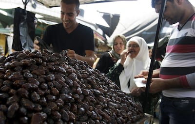 A Palestinian vendor sells dates for Ramadan at a market in the West Bank city of Jenin. AP Photo
