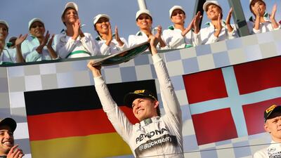 German Formula One driver Nico Rosberg, centre, of Mercedes celebrates on the podium after winning the Australian Grand Prix at the Albert Park circuit in Melbourne, Australia, on March 16, 2014. Srdjan Suki / EPA