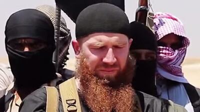 A file photo showing members of ISIL including military leader and Georgian native, Abu Omar Al Shishani, centre, speaking at an unknown location between the Iraqi Nineveh province and the Syrian town of Al Hasakah. Extremists-linked media Amaq news agency has confirmed the death of Al Shishani. Al-Itisam Media / AFP