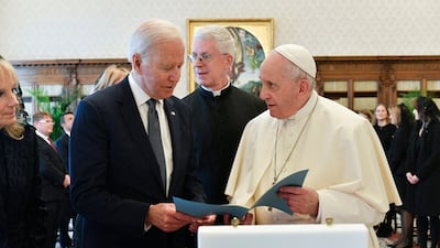 Pope Francis exchanging gifts with with Joe Biden and his wife Jill Biden during a private audience at The Vatican. AFP