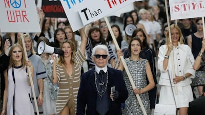 Lagerfeld leads his placard-wielding models down the runway for spring / summer 2015 ready-to-wear. The whole stage was about protesting. Reuters