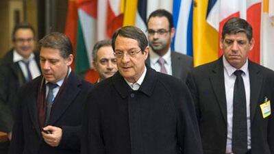 Nicos Anastasiades, Cyprus's president, centre, leaves the Eurogroup meeting in Brussels. Cyprus agreed to the outlines of an international bailout. Jock Fistick / Bloomberg