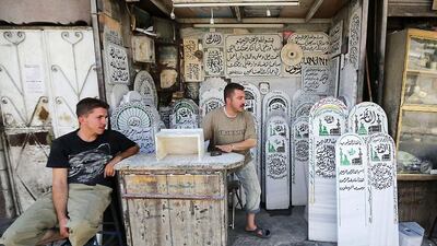 A Syrian tombstone sculptor is seen at his workshop in Damascus. Joseph / AFP Photo