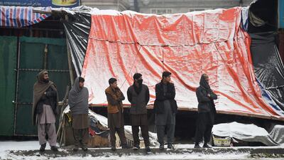 Afghan residents looks on as Afghan security personnel (unseen) guard the site of an attack near the Marshal Fahim Military Academy base in Kabul on January 29, 2018. Wakil Kohsar / AFP