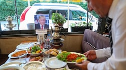 A waiter puts the finishing touches on a table at a restaurant that has been symbolically reserved and prepared for US President Donald Trump ahead of the Nato summit in Ankara. Reuters