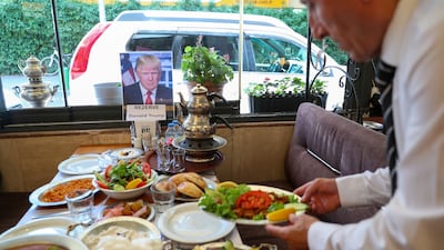 A waiter puts the finishing touches on a table at a restaurant that has been symbolically reserved and prepared for US President Donald Trump ahead of the Nato summit in Ankara. Reuters