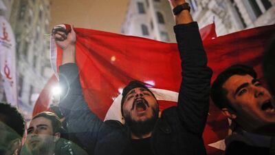 Protesters waving flags chant slogans outside the Dutch consulate in central Istanbul's Istiklal Avenue, the main shopping road of Istanbul, early Sunday on March 12, 2017 as the escalating dispute between Turkey and the Netherlands spilled over after a Turkish minister was denied entry to her consulate in the Netherlands. Emrah Gurel/AP Photo