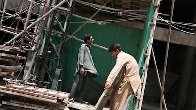 Construction site of a new apartment block in Karachi. Private developers have resorted to building gated communities in major cities.. Asim Hafeez / Bloomberg News
