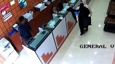 A woman suspected of attempting to rob a currency exchange with a replica gun while dressed in a burqa has been arrested. Courtesy Abu Dhabi police