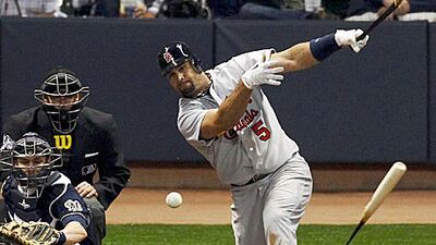 Albert Pujols breaks his bat against the Milwaukee Brewers in the eighth inning.