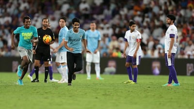 Two spectators ran onto the pitch during the match. Christopher Pike / The National
