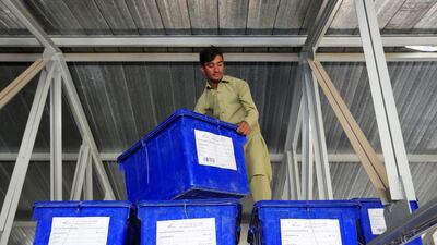 A worker stacks materials for Afghanistan's parliamentary elections in October 2018. Reuters