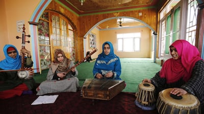 Kashmiri Muslim girls play instruments and sing Sufi music under the tutelage of music teacher, Muhammad Yaqoob Sheikh, on the outskirts of Srinagar. AFP