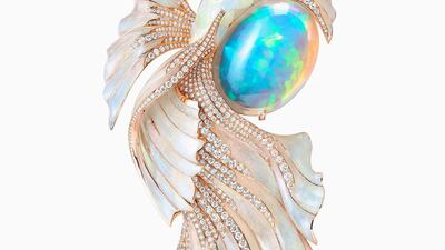A koi swims around a central, detachable, opal, at Boucheron