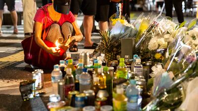 A woman lights joss sticks outside of Yamato-Saidaiji Station where Mr Abe was shot. Getty Images