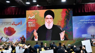 Hezbollah supporters raise their hands as they listen to a speech by Hezbollah leader Hassan Nasrallah. EPA