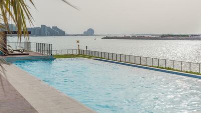 The swimming pool and complex overlooks nearby Yas Island. Courtesy LuxuryProperty.com