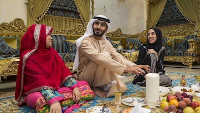 Emirati TV presenter and comedian Abdullah Al Qassab, with his mother Badria Mansoor, left, and his wife Muna Abbas at their home in Sharjah. Antonie Robertson / The National