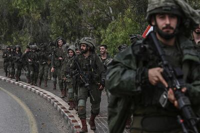 Israeli army soldiers patrol at an undisclosed location in northern Israel near the border with Lebanon on October 15. AFP