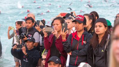 Spectators cheer the Ironman athletes at Jumeirah beach in Dubai. Leslie Pableo for The National