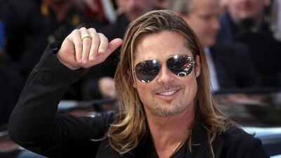 Brad Pitt waves upon arrival at the Empire cinema in Leicester Square. Neil Hall / Reuters