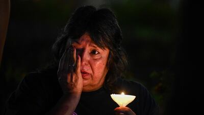 A woman attends a vigil for the victims of the Texas floods. AFP