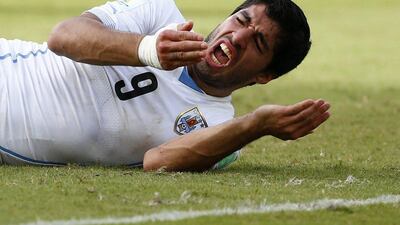 Luis Suarez reacts after his clash with Giorgio Chiellini on Tuesday in which he appeared to bite the Italian at the 2014 World Cup. Tony Gentile / Reuters / June 24, 2014