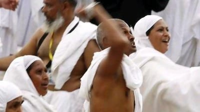 Muslim pilgrims cast seven stones at a pillar that symbolizes Satan during the annual haj pilgrimage, as part of a haj pilgrimage rite, on the first day of Eid al-Adha in Mina, near the holy city of Mecca.