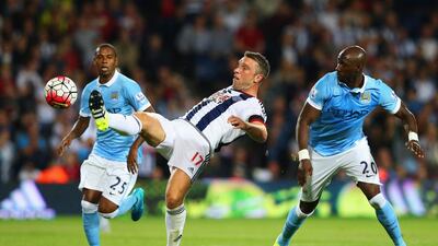 Rickie Lambert of West Brom is watched by Eliaquim Mangala of Manchester City. Alex Livesey / Getty Images / August 11, 2015