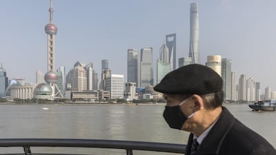 A pedestrian wearing a protective mask walks on the Bund waterfront in Shanghai, China. More than 20,000 coronavirus infection cases have now been recorded globally and the death toll in China has risen above 400 people. Bloomberg