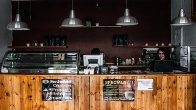 A worker sits in a darkened cafe after the electricity supply is cut off during a load-shedding power outage period in Johannesburg, South Africa, on Thursday, Feb. 14, 2019. Eskom Holdings SOC Ltd. cut supplies for the fifth day on Thursday and warned its power generation system remains "vulnerable." Photographer: Waldo Swiegers/Bloomberg