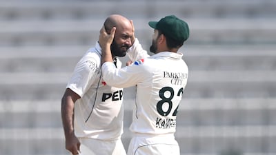 Sajid Khan is congratulated by Kamran Ghulam. Getty Images