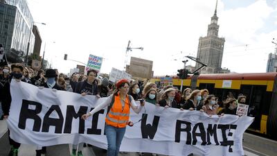 Young environmental activists take part in a demonstration in Warsaw, Poland. The banner reads 'Hand in hand'. Reuters