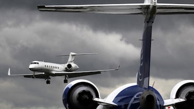 A business jet comes in to land behind a Bombardier CRJ900 plane at Farnborough in southern England. Luke MacGregor / Reuters