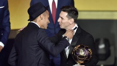 Argentine forward Lionel Messi, right, embraces Barcelona teammate Neymar after receiving the Fifa Ballon d’Or award for Player of the Year at the Kongresshaus in Zurich on Monday night. Fabrice Coffrini / AFP