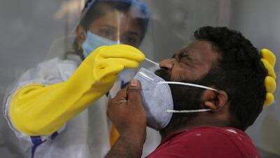 A health worker takes a nasal swab sample to test for Covid-19 in Hyderabad, India. India has the third-highest coronavirus caseload after the United States and Brazil, and the fourth-highest death toll in the world. AP