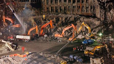 Workers and heavy machinery pictured in 2001 at the remaining facade of 1 World Trade Center at ground zero in New York