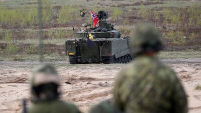 A Norwegian CV90 fighting vehicle in action during a Nato military exercise. EPA.