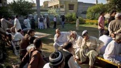 Visitors gather at the family home in Jhelum to offer comfort to relatives of Saahil Saeed.