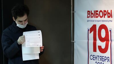 A man reads his ballots at a polling station inside the Gulag History Museum in Moscow. Reuters