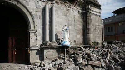 Debris and rubble surround the Santa Catalina de Alejandria Parish. Reuters