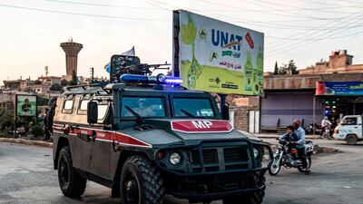 Russian military police vehicles drive through a street in the northeastern Syrian city of Qamishli. AFP