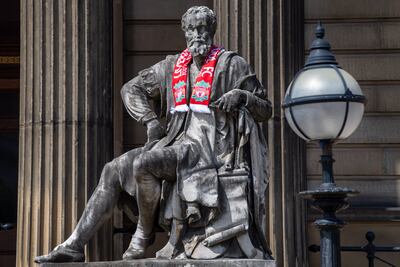 A statue is decorated with a Liverpool football scarf outside the Walker Art Gallery in Cultural Quarter. Darren Robinson for The National