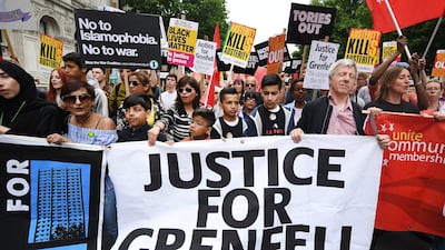 Demonstrators at anti-austerity protests in London hold a banner demanding justice for the victims and survivors of the Grenfell tower fire, which claimed at least 80 lives when a block of social housing caught fire on June 14