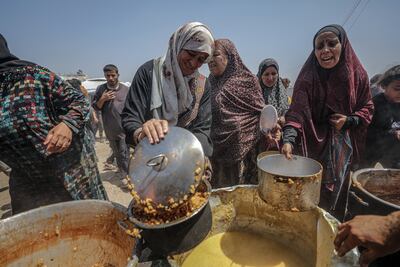 Displaced Palestinians gather to receive food from a charity kitchen in Jabalia camp, northern Gaza Strip, on May 9. EPA