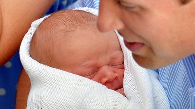 Prince William the Duke of Cambridge holds his new-born baby boy in front of the world's media. AFP PHOTO / John Stillwell