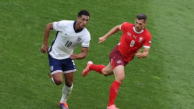 England's Jude Bellingham being chased by Remo Freuler of Switzerland. EPA